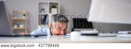 Sneaky Mature Man Avoiding Work In Office