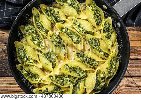 Pasta Shells Conchiglioni Stuffed With Spinach And Cheese Baked With Sauce In A Pan. Wooden Backgrou