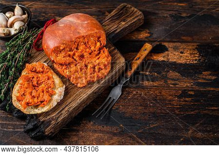 Sobrassada Cured Pork Meat Sausage On Bread Slice. Dark Wooden Background. Top View. Copy Space