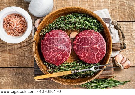 Fresh Meat Fillet Mignon Steaks From Beef Tenderloin. Wooden Background. Top View