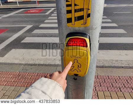 Someone In White Jacket Is Pressing The Crosswalk Traffic Light Button. In The Red Part Of The Yello