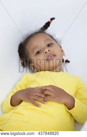 Portrait Of A Funny Little African American Girl With Pigtails.