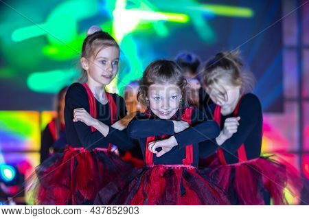 Little Girls Are Performing A Dance Number. Dance For Helovinna In Red Suits. Girl Dancing. Emotiona