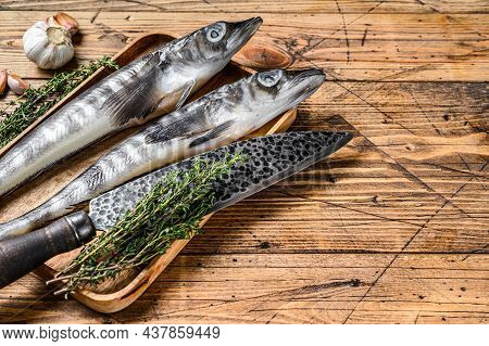 Raw Mackerel Icefish In A Wooden Tray. Wooden Background. Top View. Copy Space