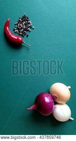Multicolored Onion Turnip, Chili Pepper, Peppercorns On A Dark Green Background