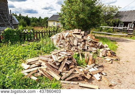 Chopped And Stacked Up Dry Firewood At The Countryside. Stock Pile Of Timber, Chopped Down Trees At 