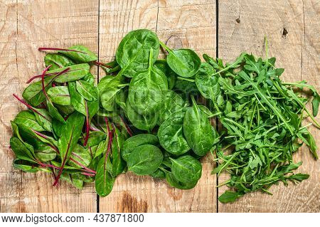 Mix Salad Leafs, Arugula, Spinach And Swiis Chard. Wooden Background. Top View