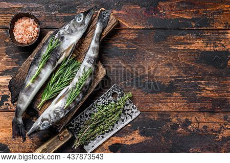 Whole Fresh Raw Icefish On A Wooden Cutting Board. Wooden Background. Top View. Copy Space