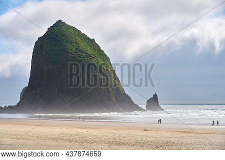 Haystack Rock Cannon Beach Afternoon. Sunrise At Haystack Rock In Cannon Beach, Oregon As The Surf W