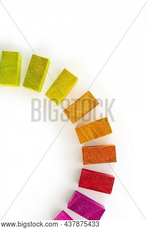 Colors in unity. Circle of colored blocks representing unity of diverse elements (colors). 
Wooden blocks placed in a a circle on a neutral white background, with natural shadows. Red in front.