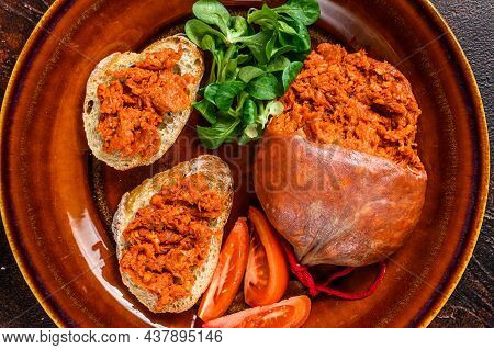 Toasts With Sobrassada Cured Pork Meat Sausage And Tomato. Dark Background. Top View