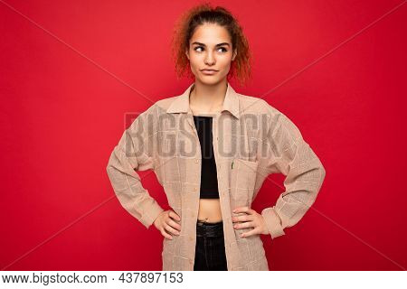 Shot Of Young Beautiful Thougtful Curly Woman Poising Isolated On Background Wall With Copy Space We