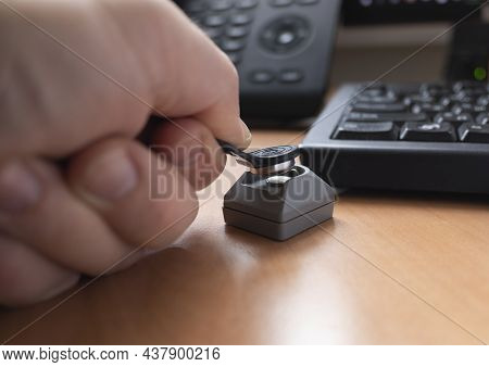A Man's Hand Puts A Touch Memory Key On The Reader To Access The Computer. The Concept Of Cybersecur