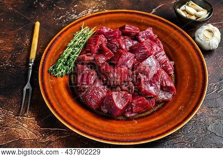 Raw Diced Deer Steak For A Venison Goulash. Dark Background. Top View