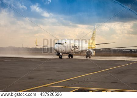 Bees Airline Yellow Plane On The Apron. Boeing 737-800 Ur-uba Passenger Aircraft. After Rain And Was