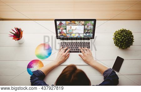 Caucasian woman using laptop for video call, with diverse elementary school pupils on screen. communication technology and online education, digital composite image.
