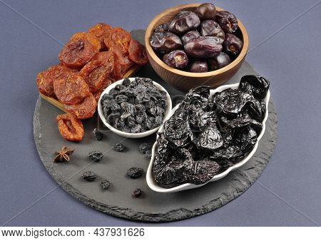 Dried Fruits. Dried Apricots, Prunes, Raisins, Dates. Proper Nutrition. Close-up. Side View. Macroph