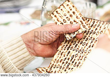 Jewish Family Celebrate Passover. Yachatz The Fourth Step Of The Passover Seder-breaking The Middle 