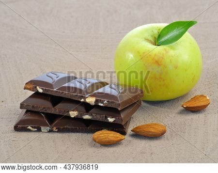 Ripe Green Apple, Dark Chocolate With Nuts, Almonds. Isolated On A Natural Background. Proper Nutrit