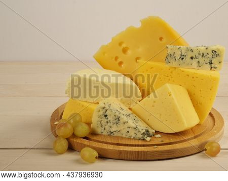 Cheese Assortment. Cheese Dor-blue, Lambert, Maasdam, Suluguni, Dutch. Cheese Slicing. On A Wooden W