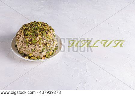 Sesame Halva With Chopped Pistachios On White Plate On Textured Background With Halva Green Text. Tr