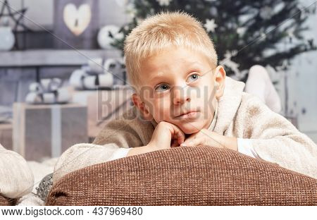 Boy Lying At Home Thinking About Christmas