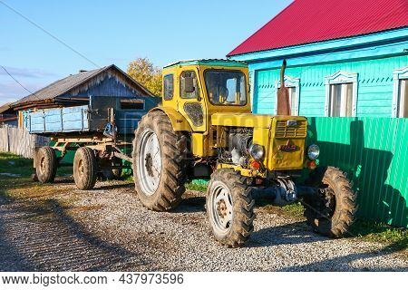 Ulu-telyak, Russia - September 28, 2021: Bright Yellow Agricultural Tractor T-40 In A Village Street