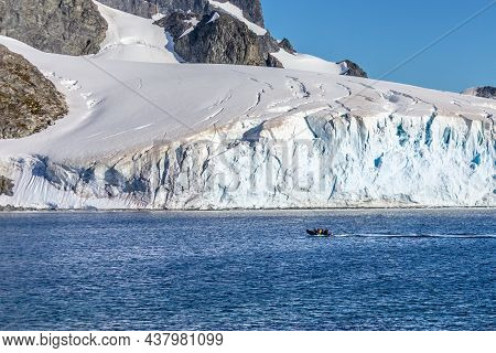Boat Full Of Tourists Passing By The Huge Glacier In The Bay Near Cuverville Island, Antarctic Penin