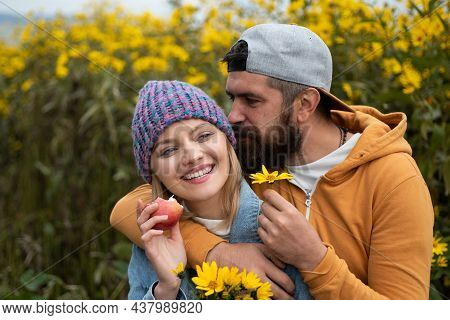 Sensual Portrait Of Young Couple In Love In Autumn Park With Flovers. Loving Couple Embracing And Ki