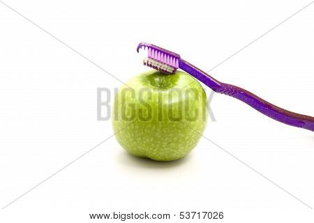 Toothbrush with Green Apple on white background