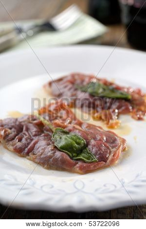 Saltimbocca alla Romana on a rustic table