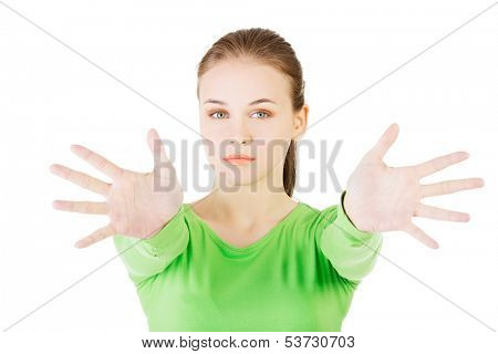 Attractive  woman with hands open in front oh her. Isolated on white. 