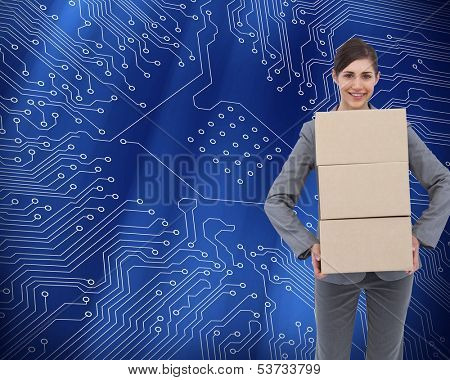Composite image of smiling businesswoman carrying cardboard boxes