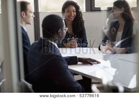 Four business people sitting and discussing at business meeting