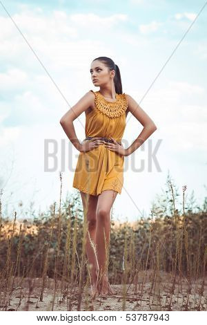 Beautiful girl standing in a field