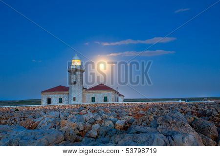 Ciutadella Menorca Punta Nati lighthouse with moon shining in sky