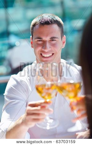 happy young couple having lanch at beautiful restaurant on by the sea on  beach