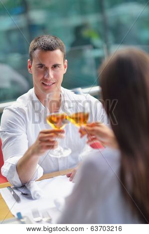 happy young couple having lanch at beautiful restaurant on by the sea on  beach