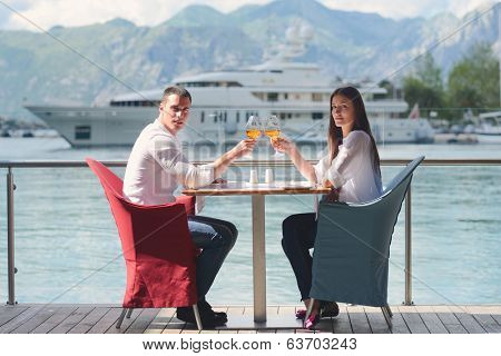 happy young couple having lanch at beautiful restaurant on by the sea on  beach
