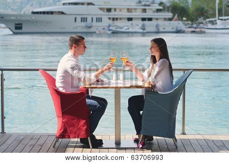 happy young couple having lanch at beautiful restaurant on by the sea on  beach