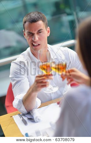 happy young couple having lanch at beautiful restaurant on by the sea on  beach
