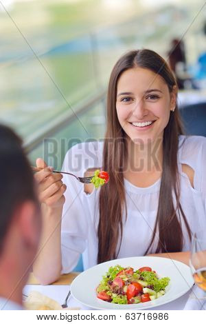 happy young couple having lanch at beautiful restaurant on by the sea on  beach