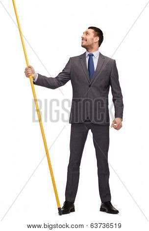 business and advertisement concept - smiling businessman holding flagpole with imaginary flag