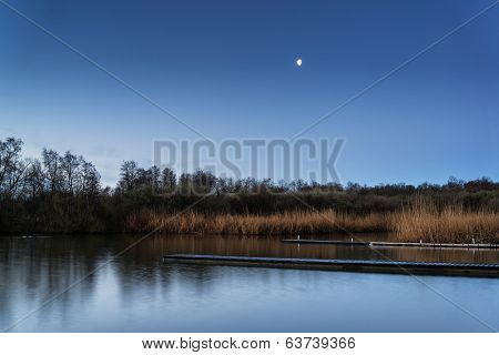 Calm Tranquil Moonlit Landscape Over Lake And Jetty