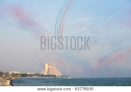 DOHA, QATAR - NOVEMBER 18, 2007: Crowds throng Doha's Corniche during a Red Arrows flying display.