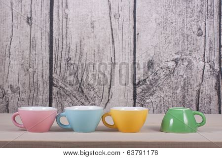Cups On Table Over Wooden Background
