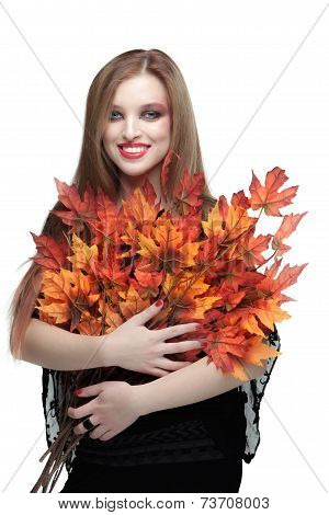 Smiling young woman with autumn maple leaves