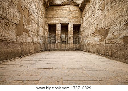 Egyptian hieroglyphic carvings in a chamber at the temple of Medinat Habu in Luxor