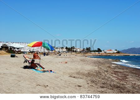Sunbathing on beach, Mojacar.