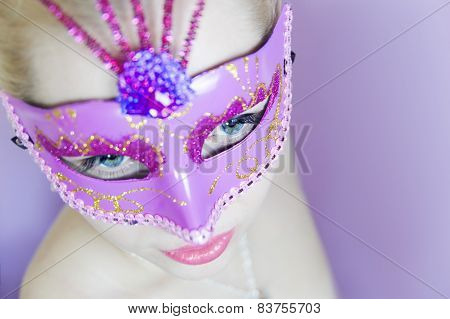 woman in pink carnival mask